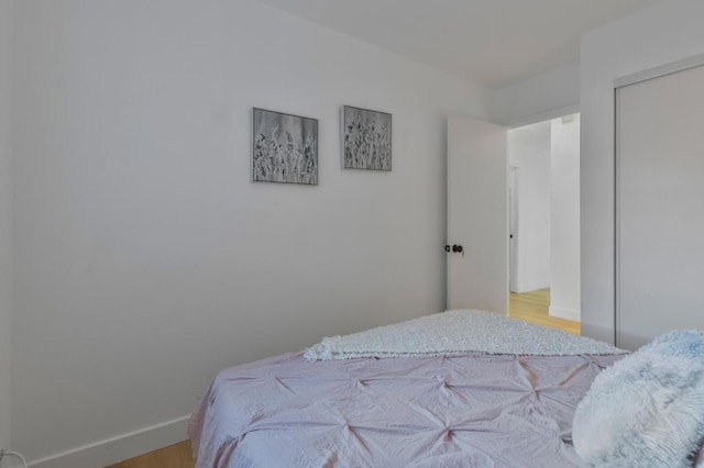 bedroom featuring light hardwood / wood-style floors and a closet