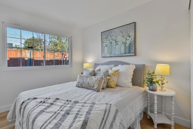 bedroom with hardwood / wood-style flooring