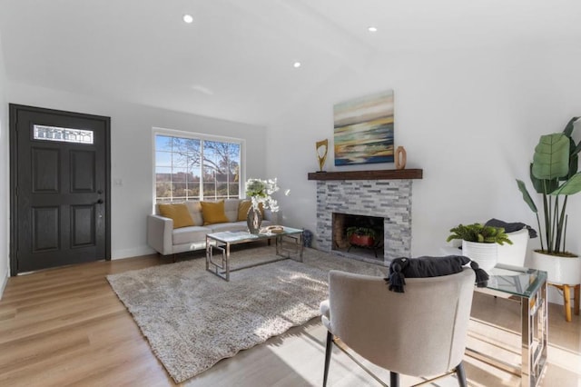 living room with vaulted ceiling with beams and light wood-type flooring