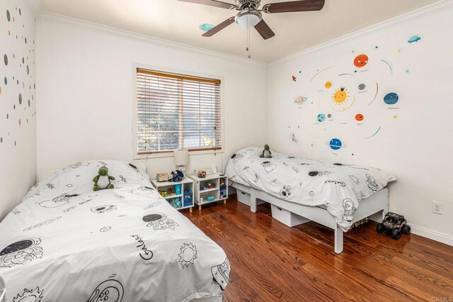 bedroom featuring dark wood-type flooring, ceiling fan, and crown molding