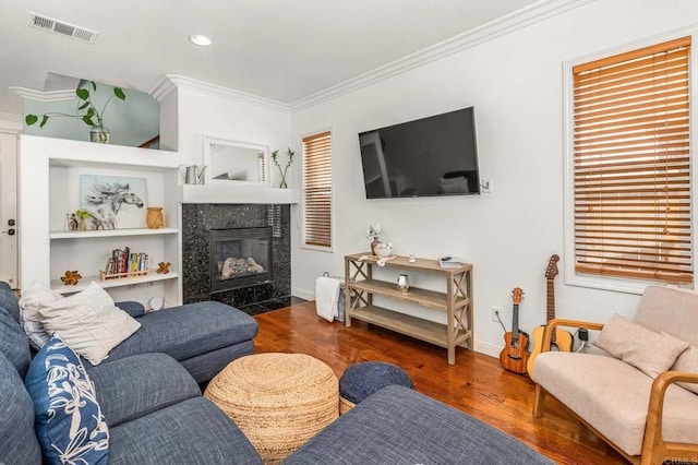 living room featuring crown molding, dark hardwood / wood-style floors, and a high end fireplace