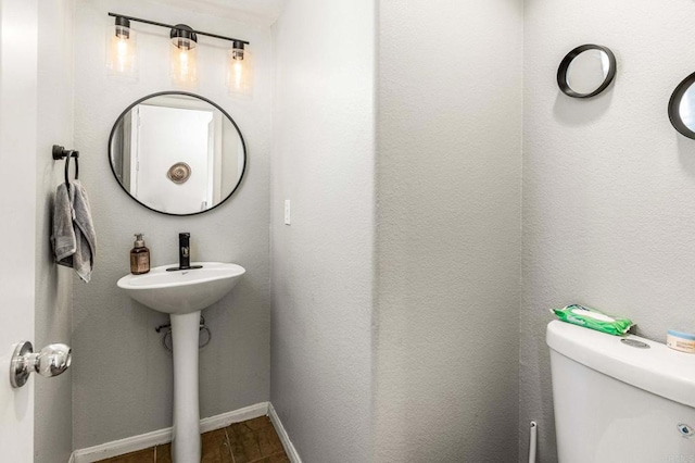 bathroom featuring hardwood / wood-style flooring and toilet