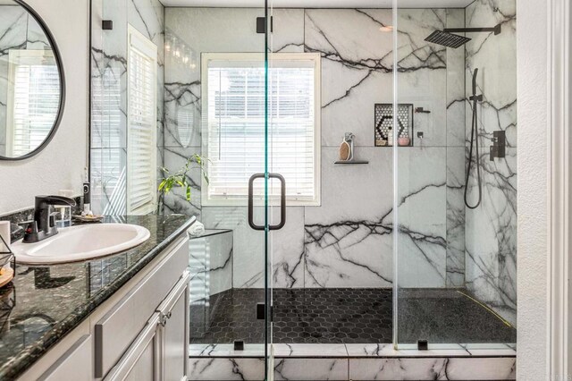 bathroom featuring vanity and a shower with shower door