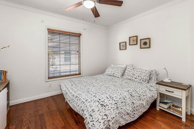 bedroom featuring dark wood-type flooring, ornamental molding, and ceiling fan