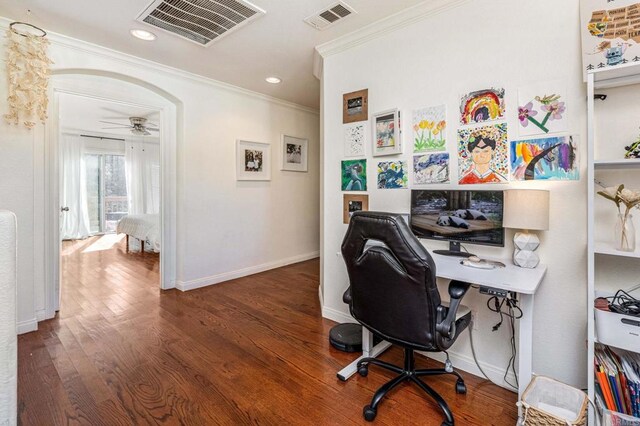 home office featuring dark hardwood / wood-style flooring, ornamental molding, and ceiling fan