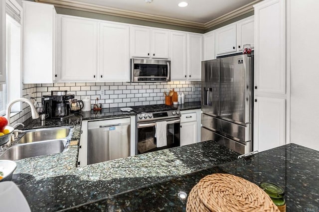 kitchen with stainless steel appliances, sink, and white cabinets