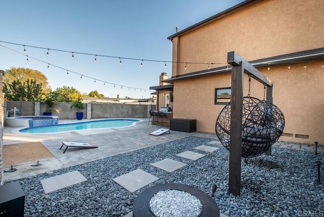 view of swimming pool with a patio area and an in ground hot tub