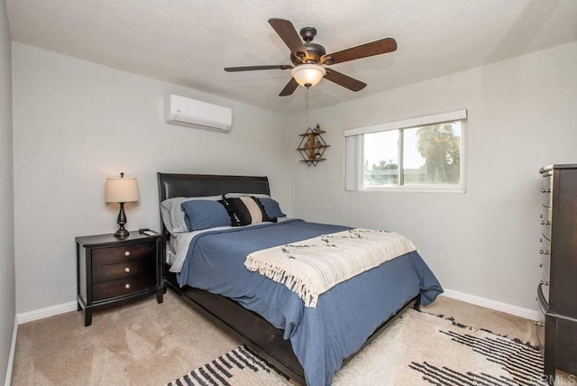 carpeted bedroom with ceiling fan and a wall unit AC