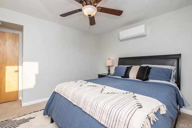 carpeted bedroom featuring ceiling fan and a wall mounted air conditioner