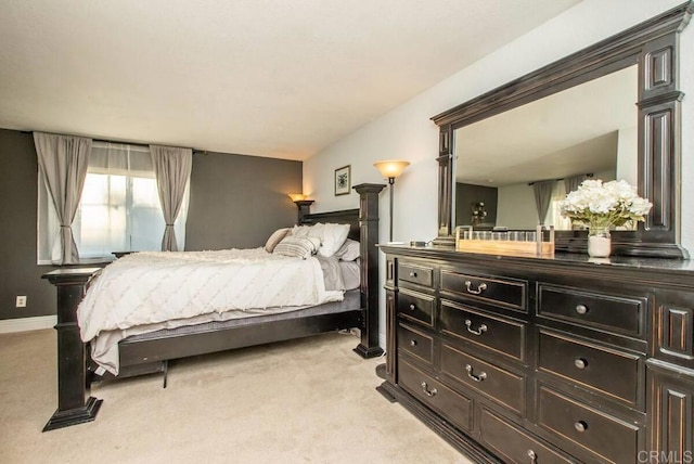 carpeted bedroom featuring decorative columns