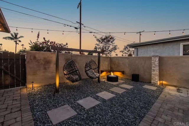 yard at dusk with a fire pit