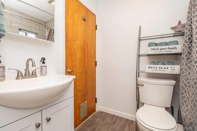 bathroom with vanity, hardwood / wood-style floors, and toilet