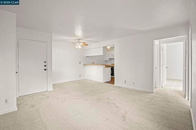 unfurnished living room featuring light colored carpet and ceiling fan