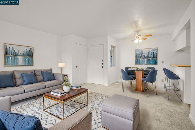 carpeted living room featuring ceiling fan