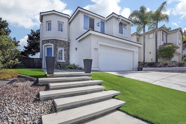 view of front of property with a garage and a front lawn