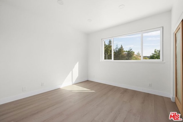 spare room with light hardwood / wood-style flooring