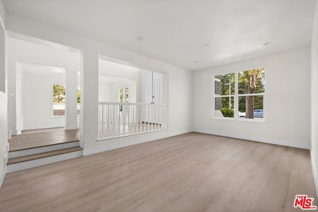 unfurnished room with light wood-type flooring