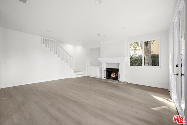 unfurnished living room with light hardwood / wood-style floors