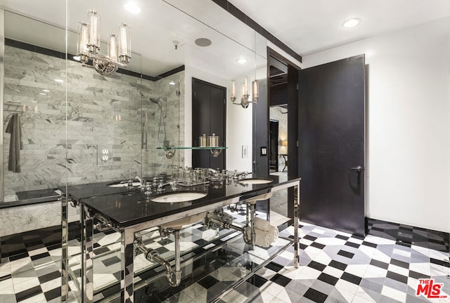 bathroom featuring a notable chandelier, vanity, and an enclosed shower