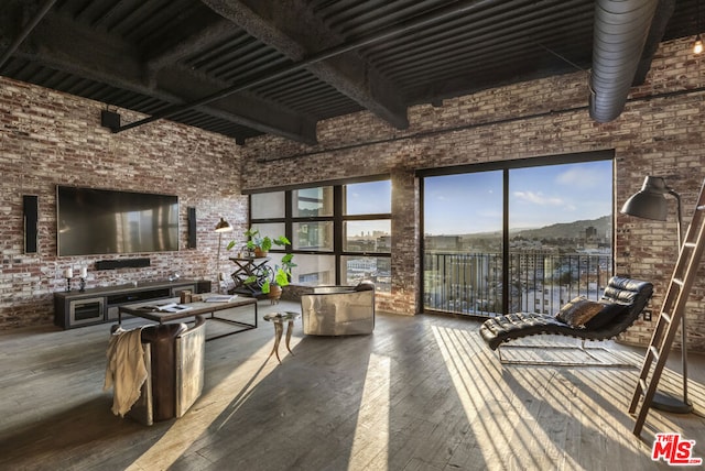 sunroom featuring a mountain view and beam ceiling