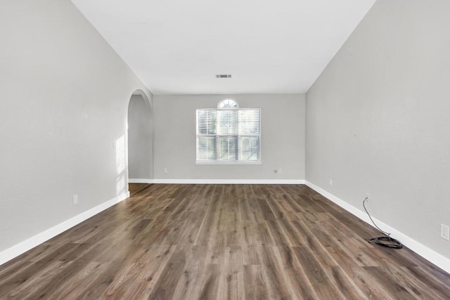 spare room featuring dark hardwood / wood-style floors