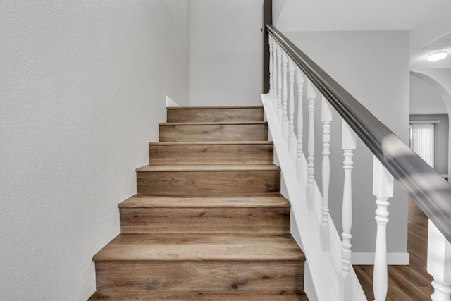 stairs featuring wood-type flooring