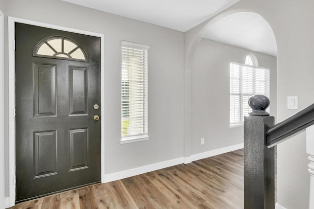 foyer entrance with hardwood / wood-style flooring and a healthy amount of sunlight