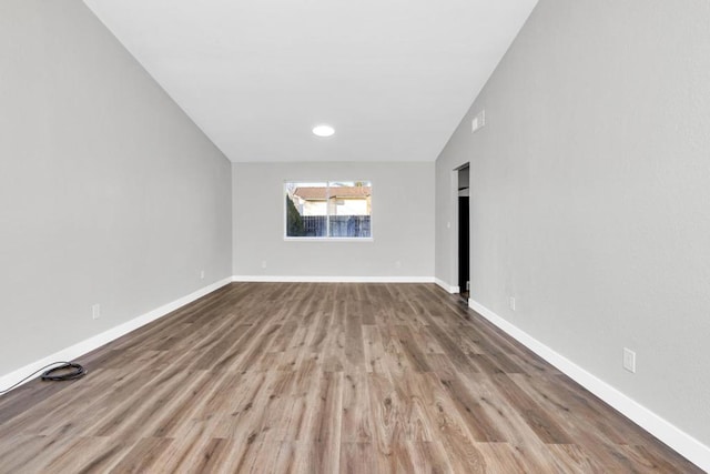 spare room with hardwood / wood-style flooring