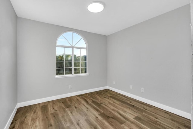 empty room with hardwood / wood-style floors