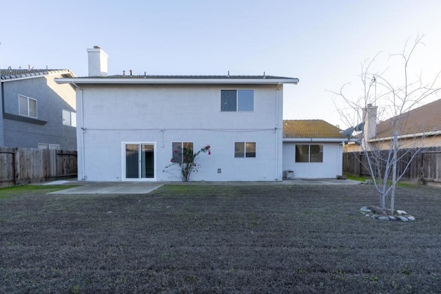 back of property with a patio and a lawn