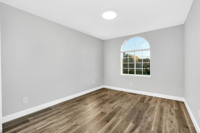 spare room featuring dark hardwood / wood-style floors