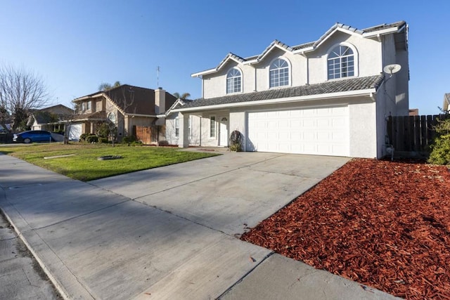 view of front property featuring a garage and a front yard