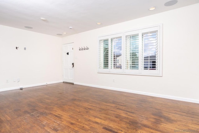 unfurnished room featuring dark hardwood / wood-style flooring