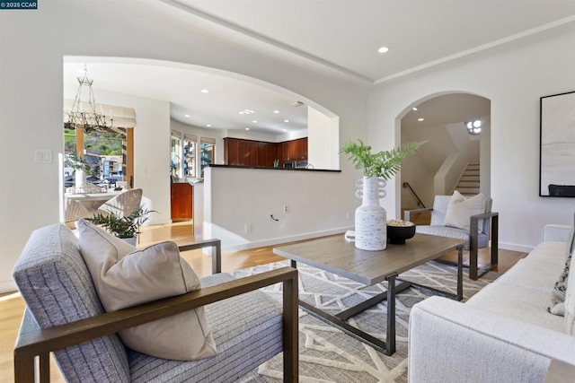 living room with a notable chandelier and light hardwood / wood-style flooring