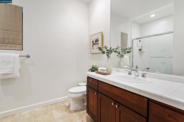 bathroom featuring vanity, toilet, and an enclosed shower