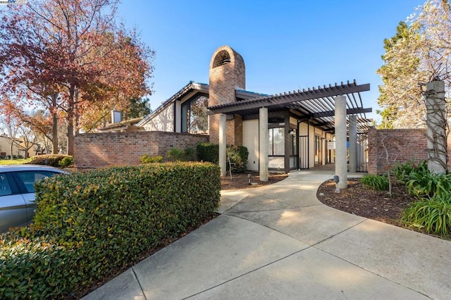 view of side of home with a pergola