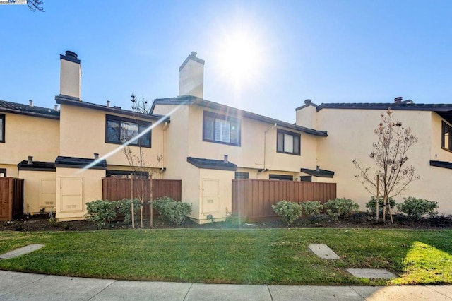 rear view of property with a yard