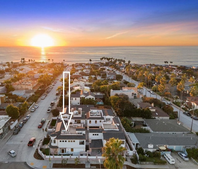 aerial view at dusk with a water view