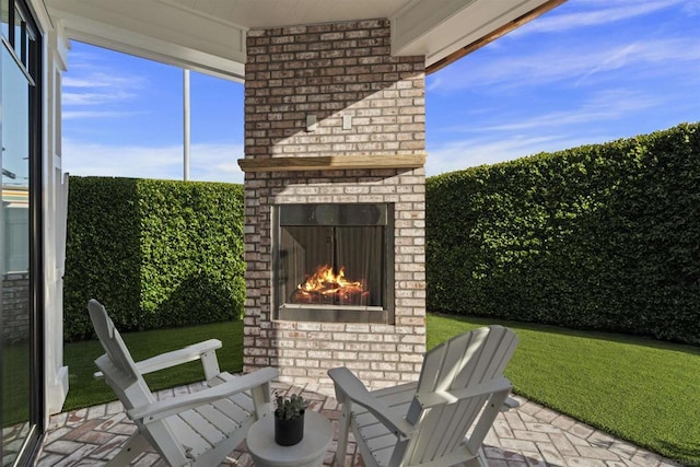 view of patio with an outdoor brick fireplace