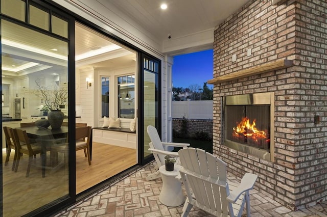 sunroom featuring an outdoor brick fireplace