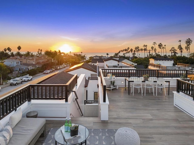 deck at dusk with an outdoor living space