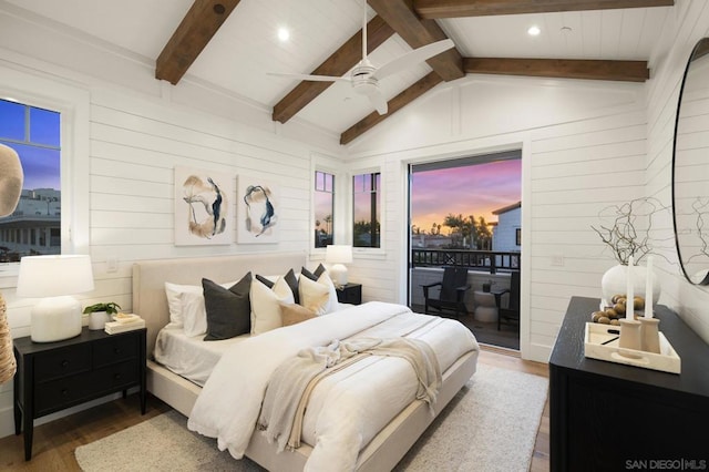 bedroom featuring wood walls, lofted ceiling with beams, wood-type flooring, access to outside, and ceiling fan