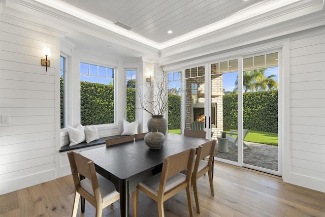 sunroom / solarium featuring wood ceiling and a healthy amount of sunlight