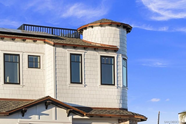 view of home's exterior featuring a balcony and solar panels