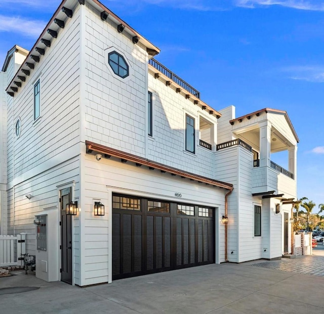 exterior space featuring a balcony and a garage