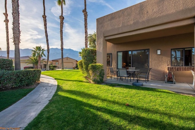 view of yard with a mountain view and a patio