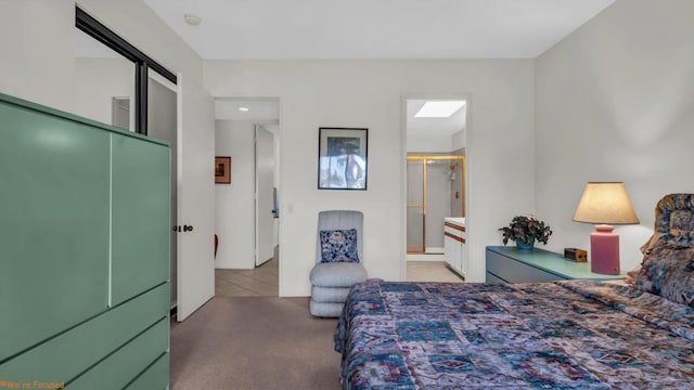 carpeted bedroom featuring ensuite bathroom and a closet