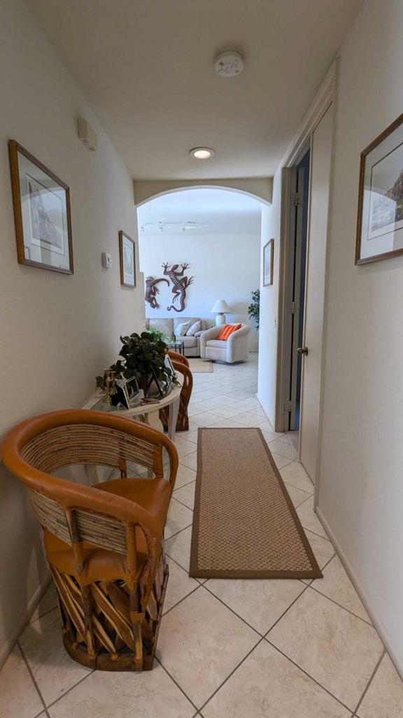 hall with light tile patterned floors