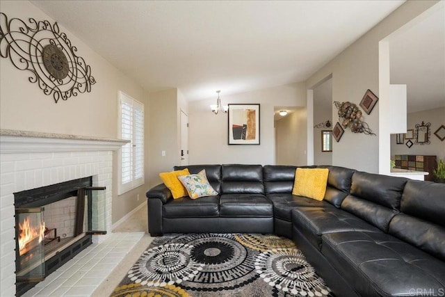 living room featuring an inviting chandelier, a fireplace, vaulted ceiling, and light carpet