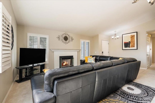 living room featuring lofted ceiling, light colored carpet, a chandelier, and a brick fireplace